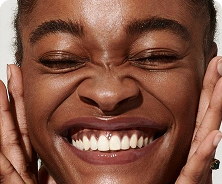 Smiling woman with radiant skin representing Olay’s science-backed skincare results